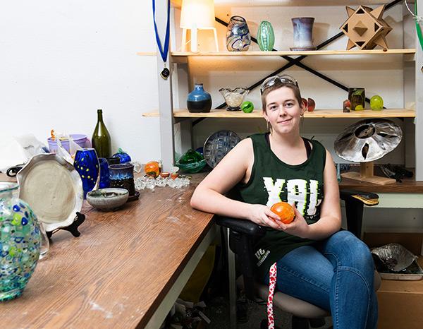 A student poses with some of her work.